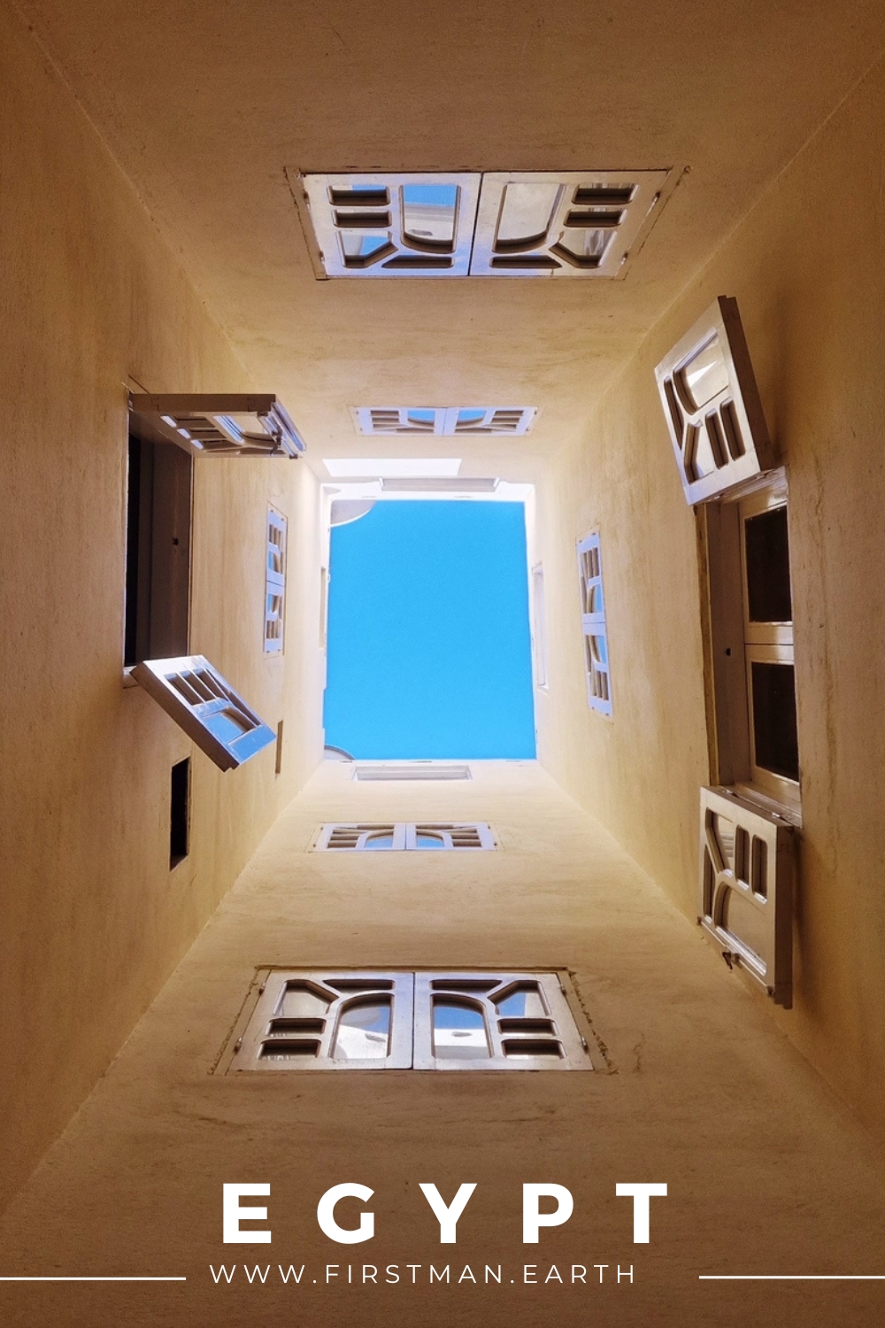 Egypt travel photography showing a unique architectural perspective of a building with windows and the sky above.