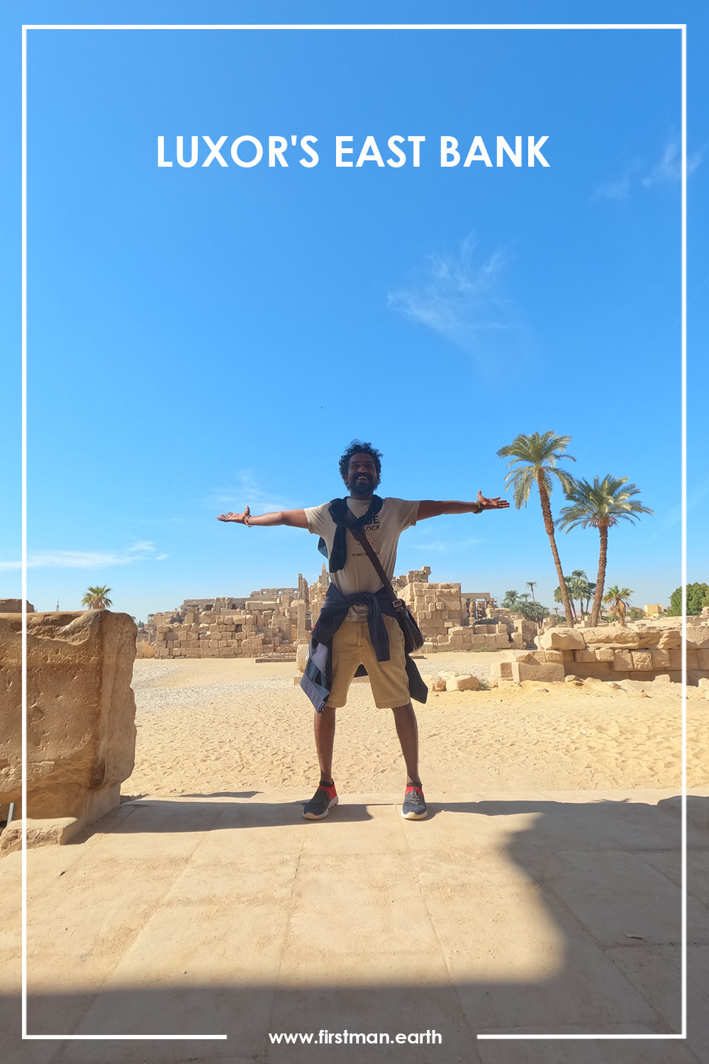 man standing in front of old structures