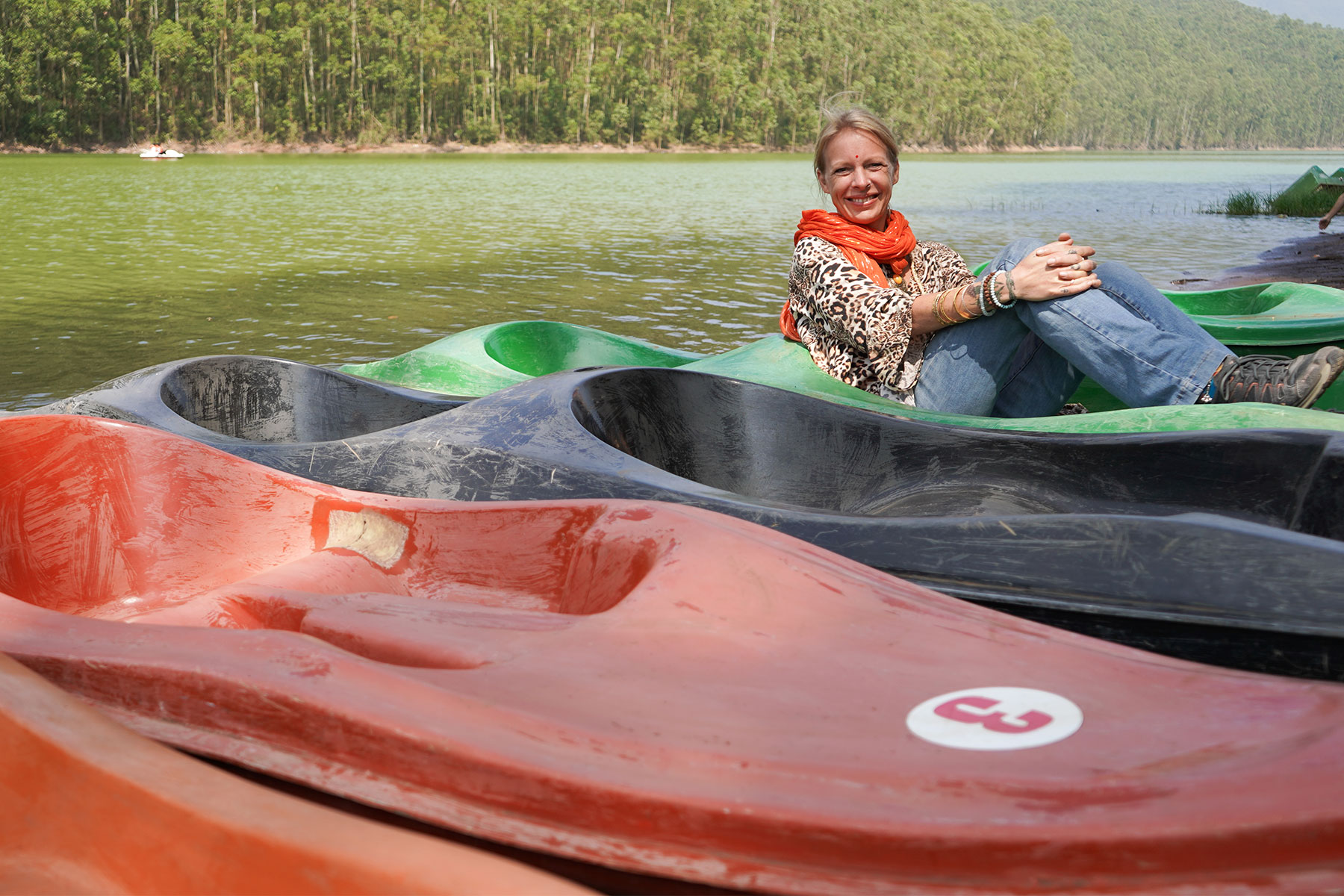 Eco-point-lady-sitting-in-boat-besides-lake-munnar-kerala-india-firstman.earth