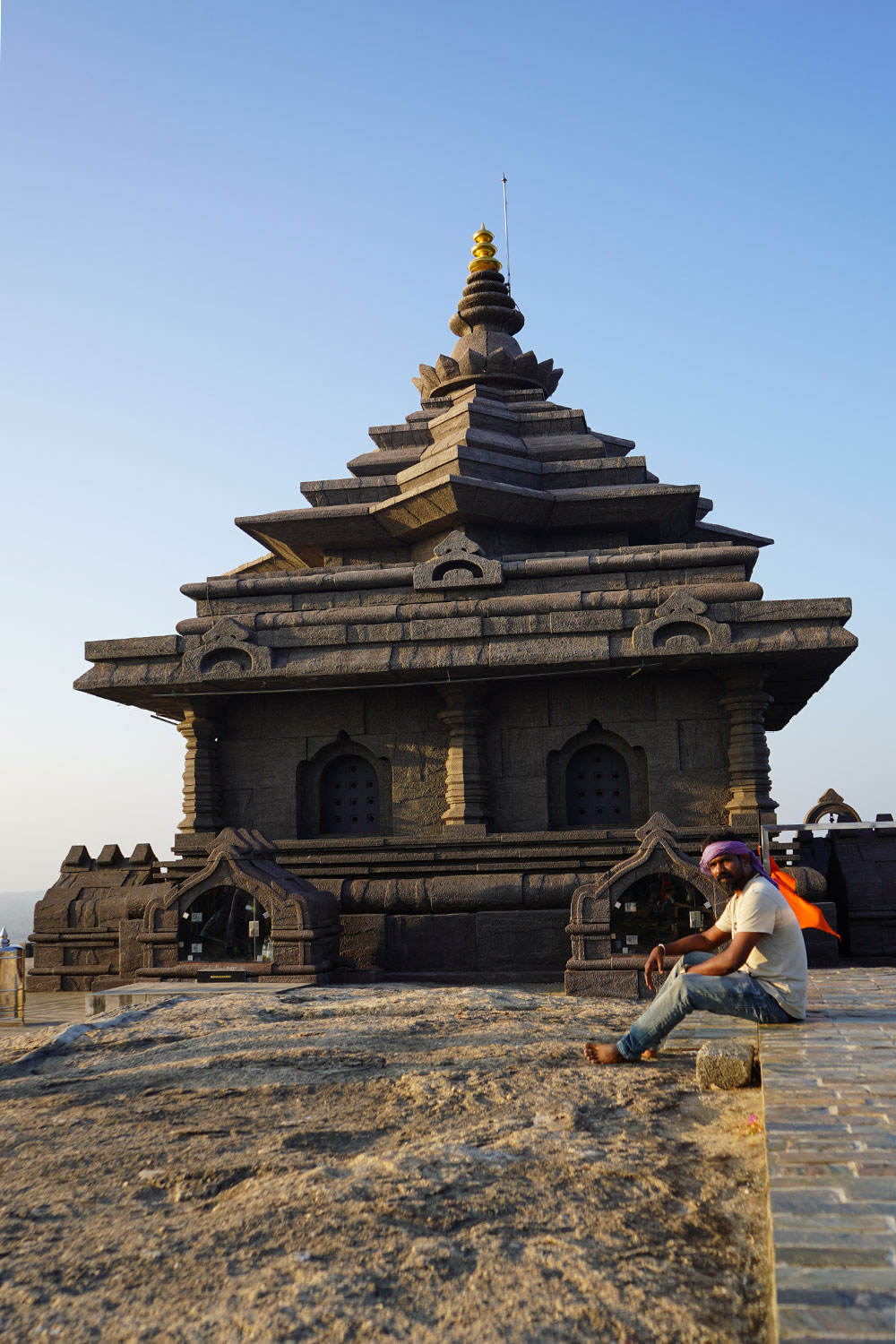 Man-sitting-infront-of-ram-temple-in-jatayu-rock-kerala-india-firstman